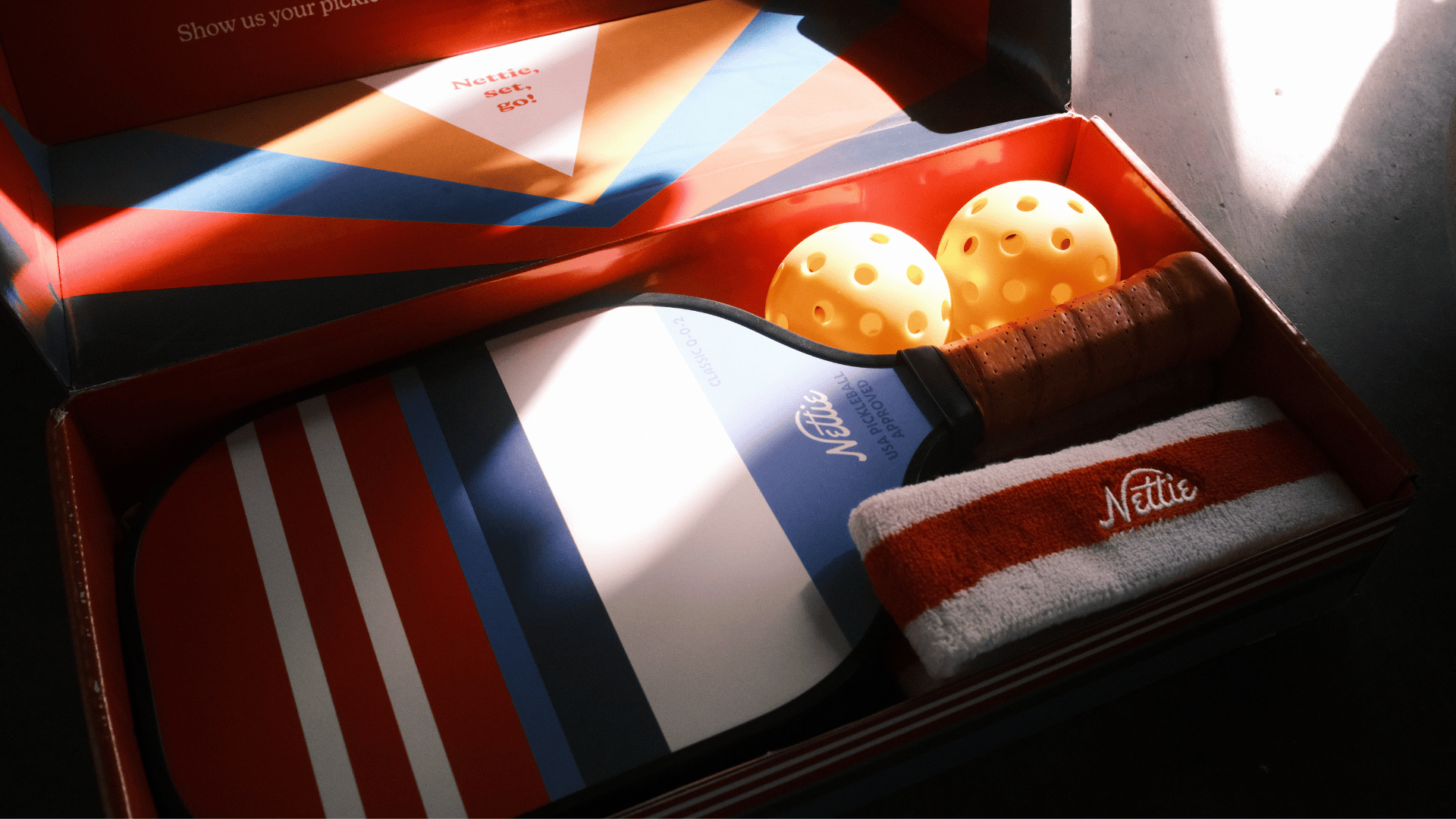 gift kit with premium pickleball paddle and balls, custom branded for Nettie