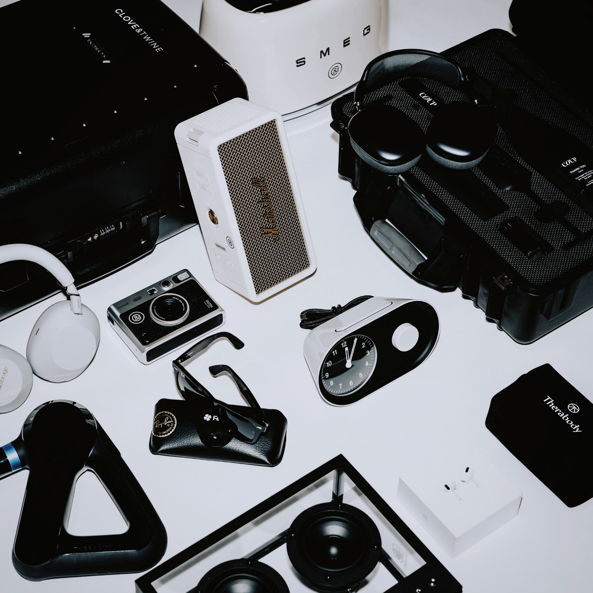 custom premium products for incentive gifting, including theragun, Marshall speaker, camera, and Coup kit