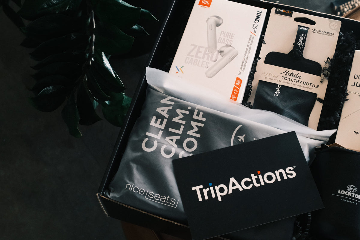 custom branded premium corporate gifting kit for TripActions including custom JBL headphones 